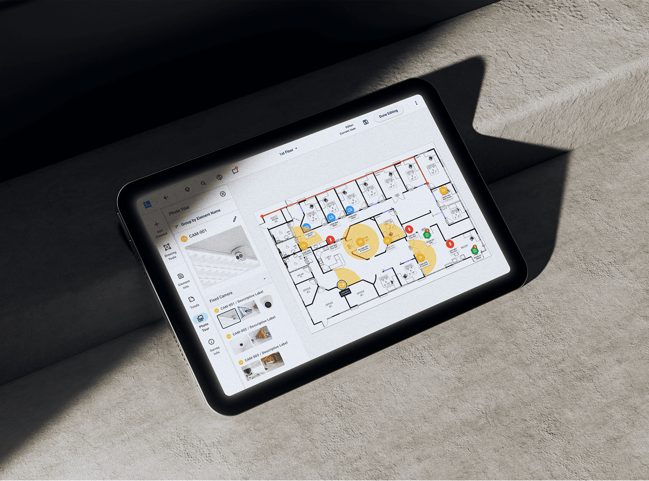 A tablet mockup on a concrete floor , showing the editors app screen