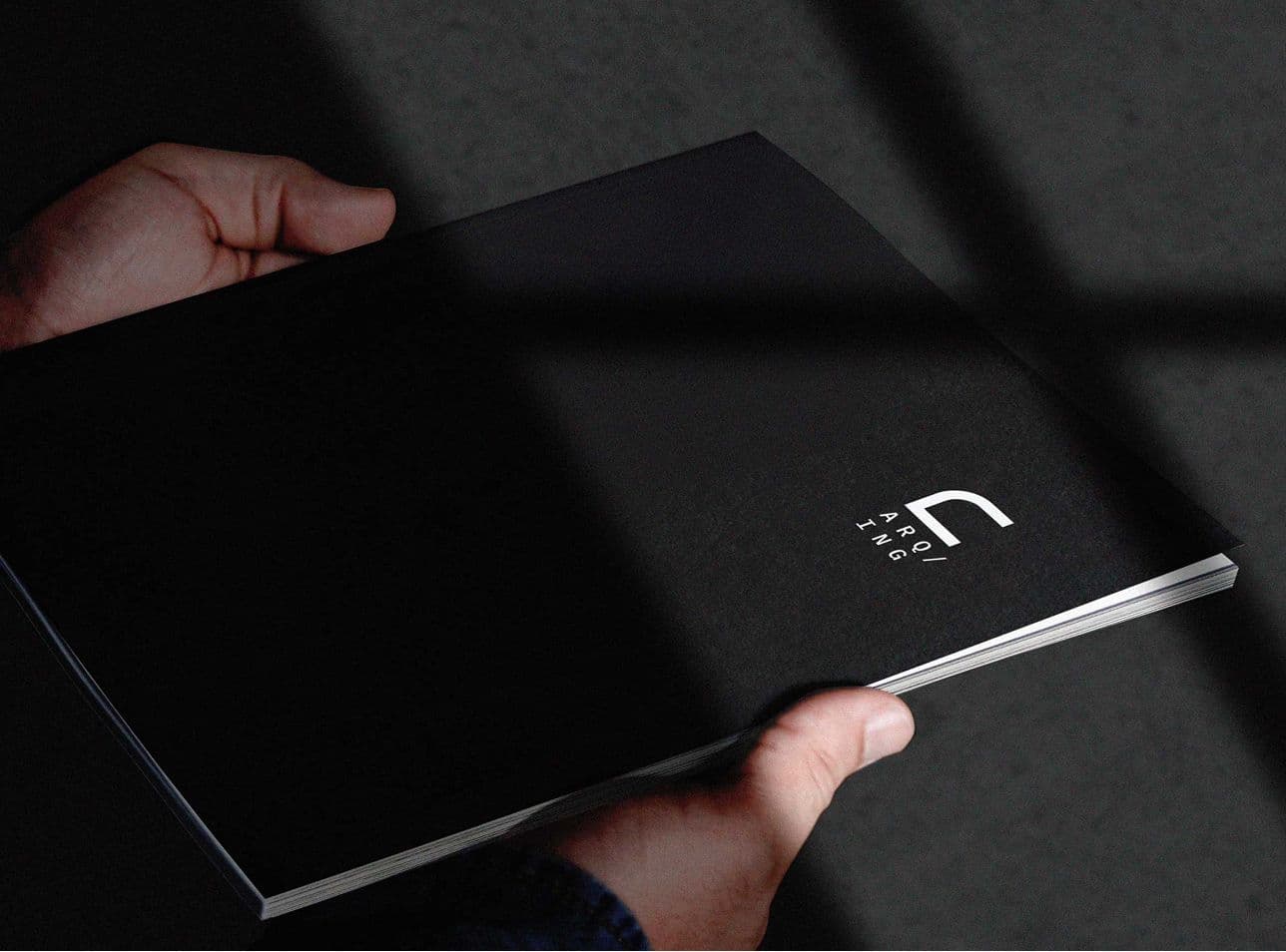a photo of 2 hands holding the printable version of the brandbook