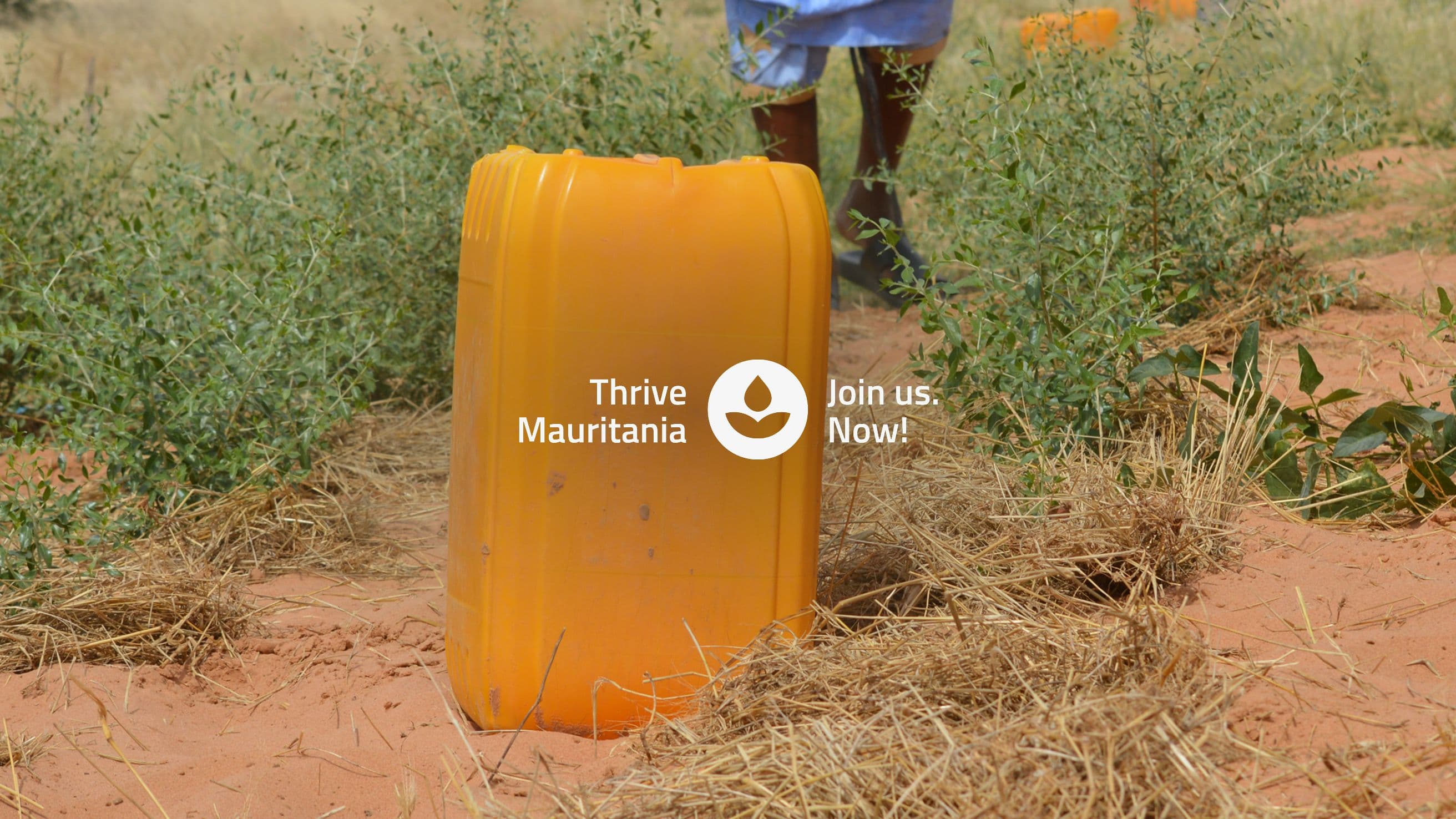 image of a yellow water tank and a local person walking on the back