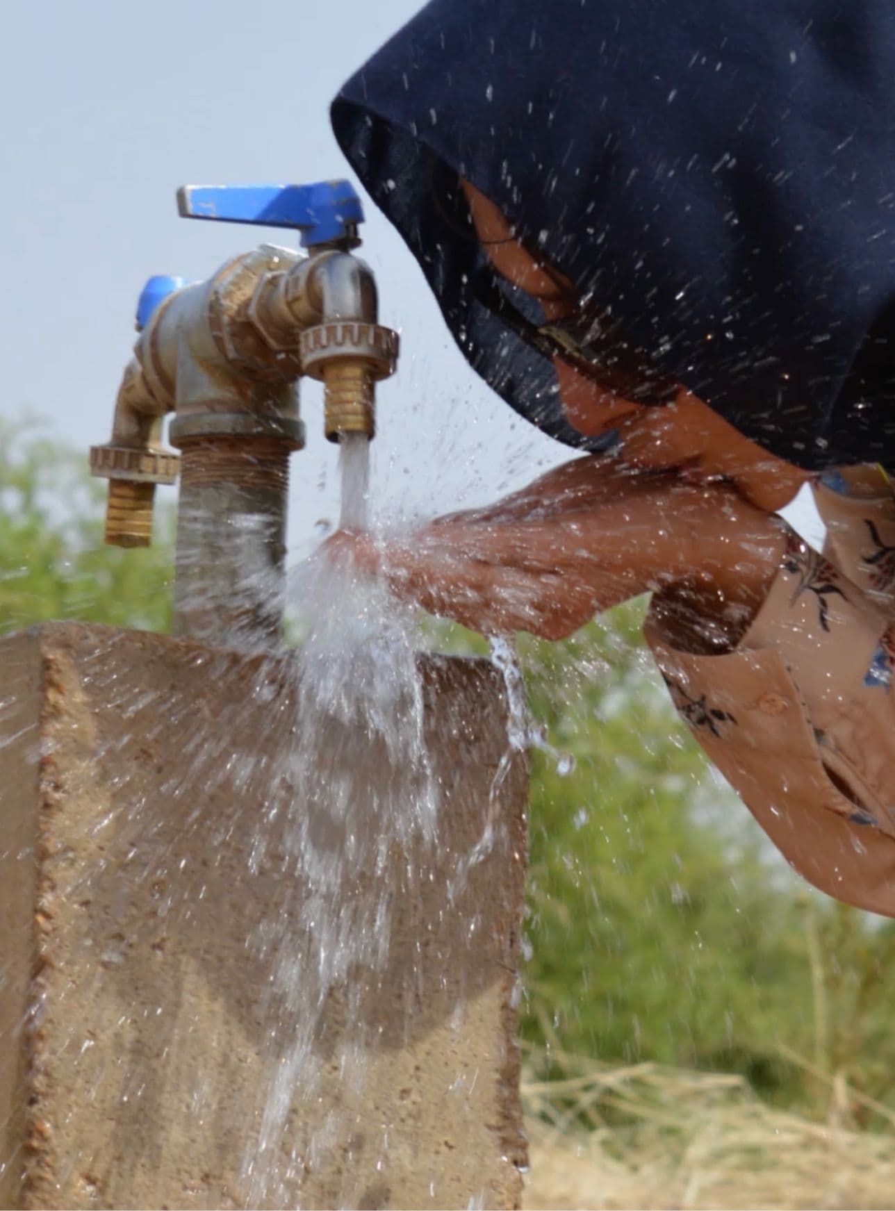a photo of a woman drinking water from a new well in Mauritania