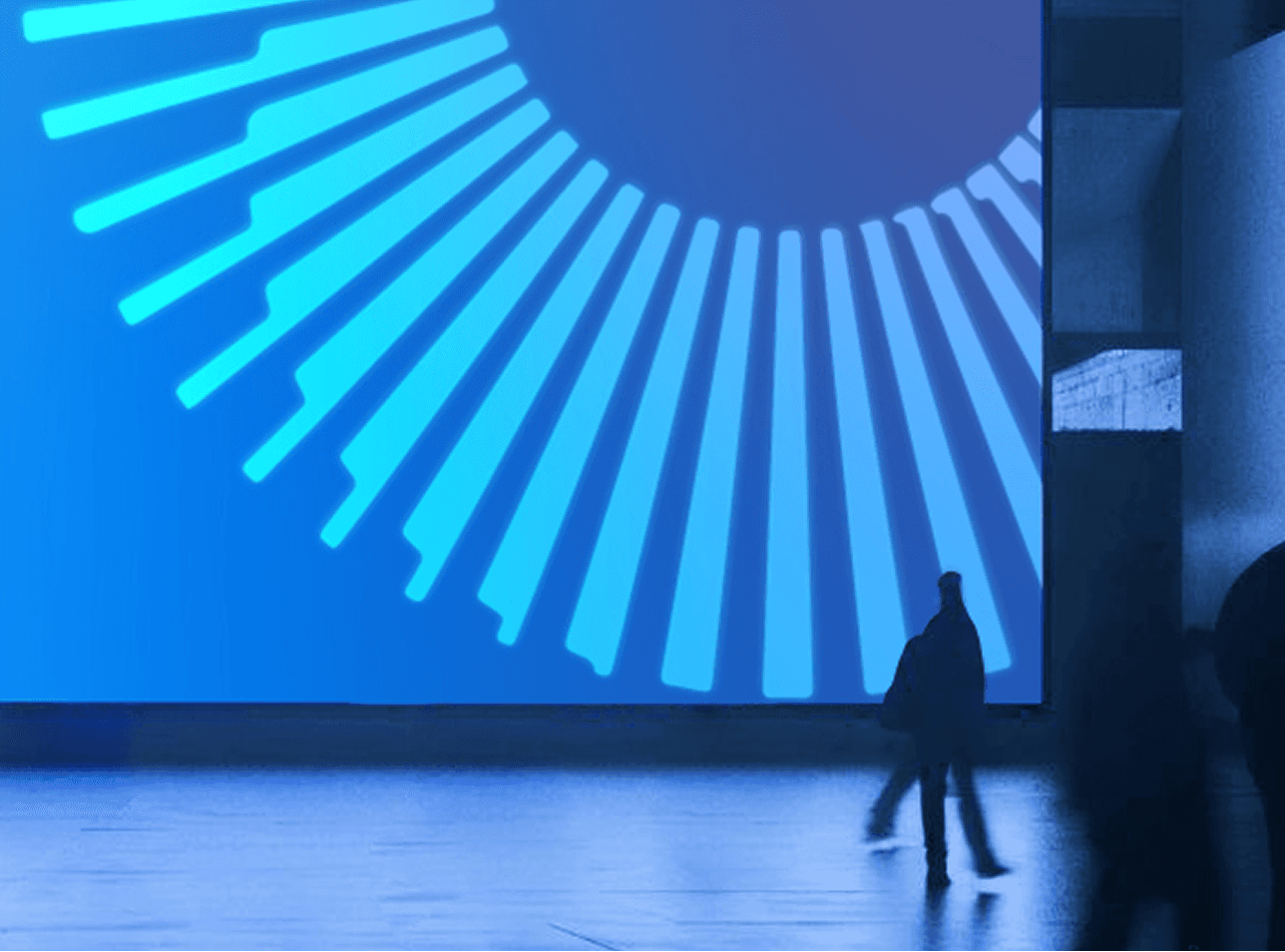 Close-up of Liberty Aurora's radial graphic on a large blue digital display.