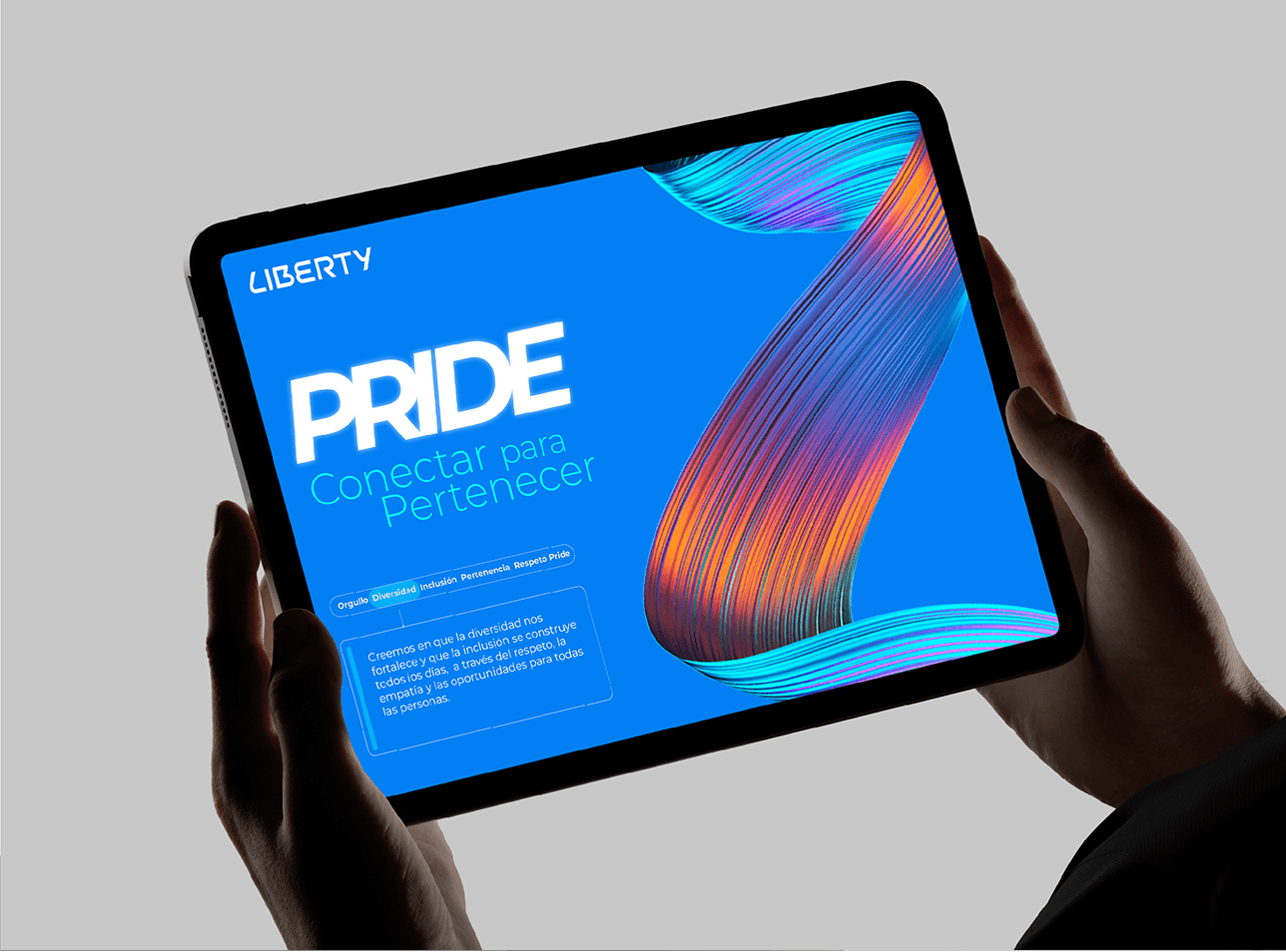 Liberty Pride campaign artwork on a tablet, with colorful ribbons on a blue background.